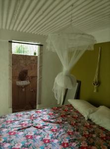 a bedroom with a bed with a canopy and a window at Kaiche in Trafalgar