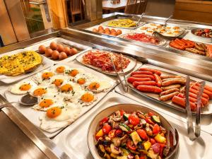 a buffet line with many different types of food at Hotel Schachenwald I Sauna I Aussenpool I Parkplatz in Premstätten