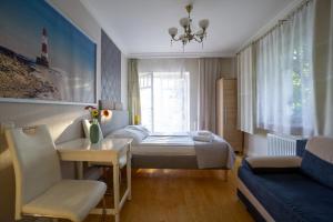 a small bedroom with a bed and a window at roomsy guest house in Sopot