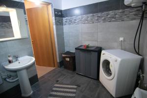 a bathroom with a washing machine and a sink at KALLIOPIs HOUSE in Paralia Katerinis +39 photos