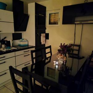 a kitchen with a table and chairs in a kitchen at Pine Tree House in Bar +2 photos