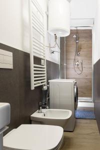 a bathroom with a white toilet and a sink at Luxury Appartament Piazza Roma in Ancona