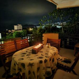 a table with a table cloth with candles on a balcony at Pine Tree House in Bar