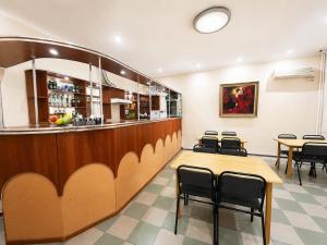 a restaurant with a bar and tables and chairs at Жастар in Astana