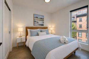 a bedroom with a large bed and a window at Amazing 1Bedroom Great Location presented by TripMontreal in Montreal