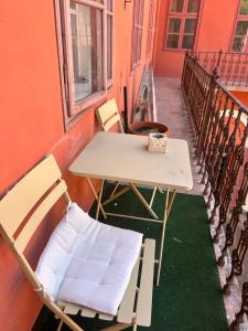a table and chairs sitting on a balcony at Graffiti Downtown Room in Szeged