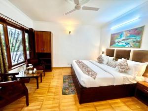 a bedroom with a bed and a living room at Hotel Ambience Hill Nainital - near Bhowali in Nainital
