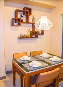 a dining room with a table with chairs and a light at Mactan Daily Staycation in Punta Engaño