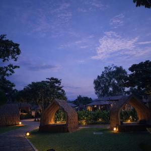 a night view of a garden with two arch bridges at Mactan Daily Staycation in Punta Engaño