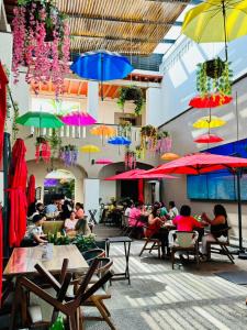 a group of people sitting at tables under umbrellas at Hotel Casa Antigua in Oaxaca City