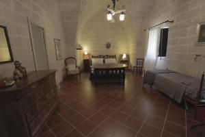 a bedroom with a bed and a table in a room at Masseria Scianne in Sant'Isidoro