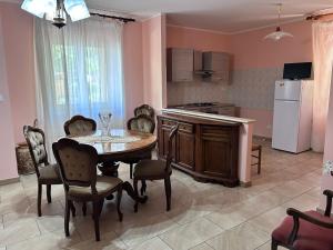 a kitchen with a table and chairs in a room at Villa Vanessa in Spoltore