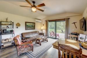 a living room with a couch and a table at On the Flathead River! Rustic Saloon-Themed Cabin in Columbia Falls