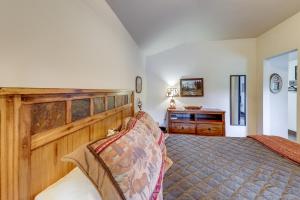 a bedroom with a large bed and a desk at On the Flathead River! Rustic Saloon-Themed Cabin in Columbia Falls