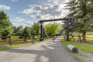 an entrance to a gate with an american flag at On the Flathead River! Rustic Saloon-Themed Cabin in Columbia Falls +16 photos