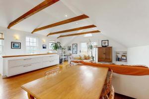 a living room with a table and a couch at Charming cottage close to the beach in Truro