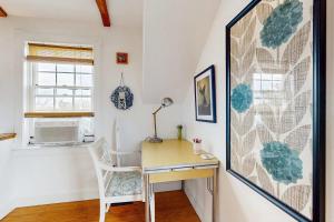a desk and a chair in a room at Charming cottage close to the beach in Truro