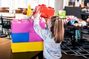 a young girl playing with a lego box at Moxy Slough in Slough