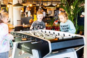 a group of children playing with a large keyboard at Moxy Slough in Slough