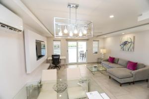 a living room with a couch and a table at 246D South Finger in Jolly Harbour