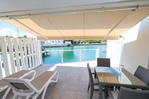 a patio with a table and chairs and a pool at 246D South Finger in Jolly Harbour