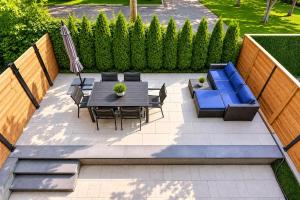 a patio with a table and chairs and a blue couch at Amazing 2BR condo with private terrace presented by TripMontreal II in Montreal
