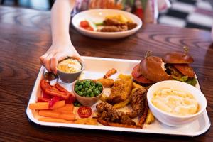 a tray of food with a sandwich and other foods at Moxy Slough in Slough +31 photos
