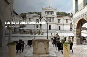 a courtyard with tables and chairs in front of a building at B&B di Cristina in Conegliano