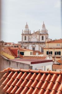 a view from the roofs of a city with a church at LEGASEA - Cascais Guesthouse in Cascais
