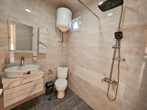 a bathroom with a toilet and a sink and a shower at Imeri Hotel in Ureki +63 photos