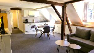 a kitchen and a living room with a table and a couch at Weingut Caspari, Familie Eggert in Traben-Trarbach