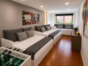 a living room with two beds and a couch at La Casa de los Inventos in Burgos +38 photos