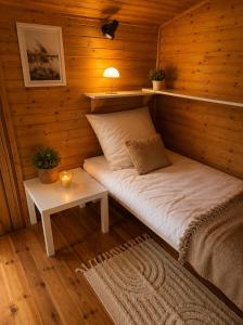 a room with a bed in a wooden cabin at Argentum Luxury Bungalov in Gąbin