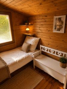 a room with two beds in a log cabin at Argentum Luxury Bungalov in Gąbin +19 photos