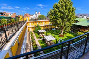 an apartment balcony with a view of a park at Casa de Avila Hotel in Arequipa