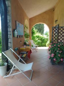 a patio with lounge chairs and a table and a window at B&B 8380 Saturnia Terme in Saturnia