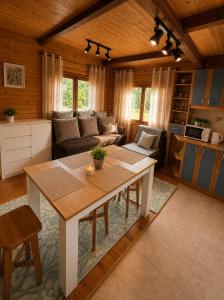 a living room with a table and a couch at Argentum Luxury Bungalov in Gąbin
