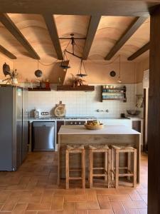a kitchen with a large kitchen island with stools at Ca Na Marina in Cala Llombards