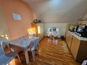 a kitchen with a table and a small table with chairs at Imeri Hotel in Ureki