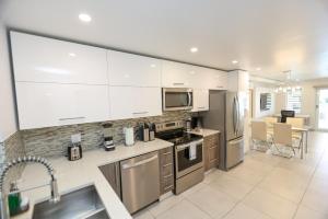 a kitchen with white cabinets and stainless steel appliances at 246D South Finger in Jolly Harbour