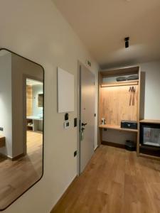 a mirror on a wall in a room at Montiva GuestHouse in Karpenisi