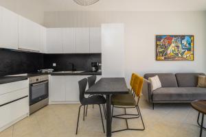 a kitchen and living room with a table and chairs at Blue Skala - Indigo Apartment I in Skala