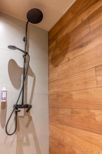 a shower in a bathroom with a wooden wall at Montiva GuestHouse in Karpenisi +98 photos