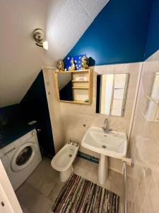a bathroom with a sink and a washing machine at Lacanau-Océan Triplex Front de mer in Lacanau-Océan