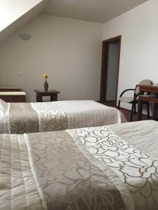מיטה או מיטות בחדר ב-Hotel Magnolia