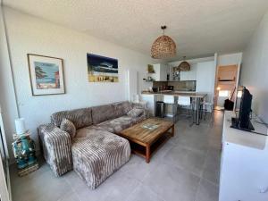 a living room with a couch and a table at Lacanau-Océan Triplex Front de mer in Lacanau-Océan