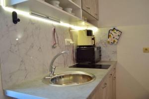 a kitchen counter with a sink and a coffee maker at DalEro Sunset Apartments Medjugorje in Međugorje +129 photos