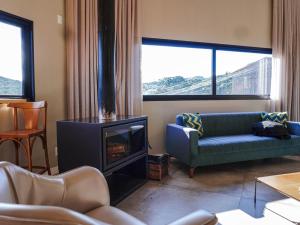 a living room with a couch and a fireplace at Pousada Villa Serrana in Bom Jardim da Serra