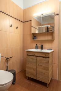 a bathroom with a sink and a toilet at Blue Skala - Indigo Apartment I in Skala +23 photos