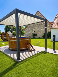 a gazebo with a hot tub in a yard at Domaine la Héroïca in Maisonnais